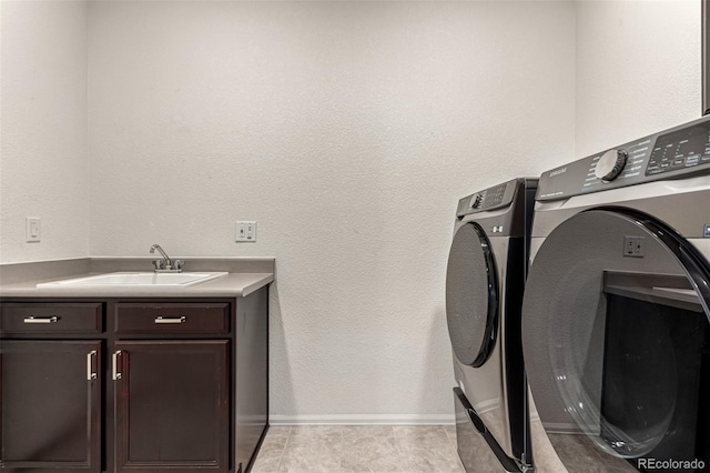 7991 Heritage Dr, Thornton, CO 80602 - laundry room with separate washer and dryer, cabinet space, baseboards, and a textured wall