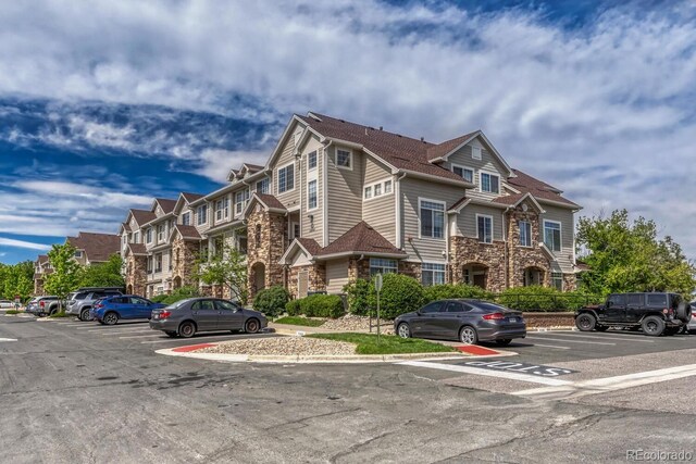 12711 Colorado Blvd Unit 714G, Thornton, CO 80241 - view of front of house with uncovered parking and stone siding