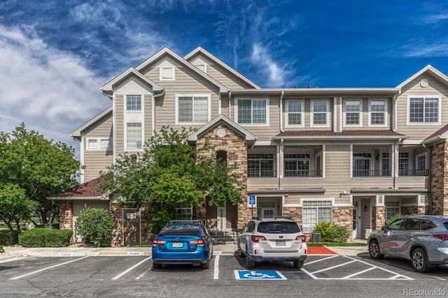 12711 Colorado Blvd Unit 714G, Thornton, CO 80241 - view of front of house with stone siding and uncovered parking
