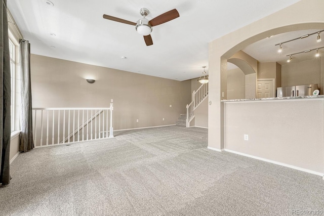 12711 Colorado Blvd Unit 714G, Thornton, CO 80241 - spare room with a ceiling fan, carpet floors, arched walkways, baseboards, and healthy amount of natural light