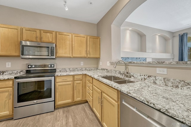 12711 Colorado Blvd Unit 714G, Thornton, CO 80241 - kitchen with appliances with stainless steel finishes, a sink, light brown cabinetry, light wood-type flooring, and light stone countertops