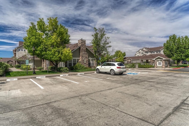 12711 Colorado Blvd Unit 714G, Thornton, CO 80241 - uncovered parking lot featuring a residential view