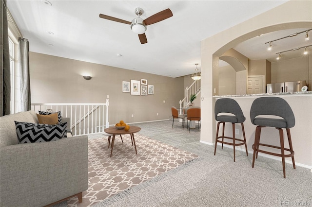 12711 Colorado Blvd Unit 714G, Thornton, CO 80241 - carpeted living area with a ceiling fan, arched walkways, and baseboards