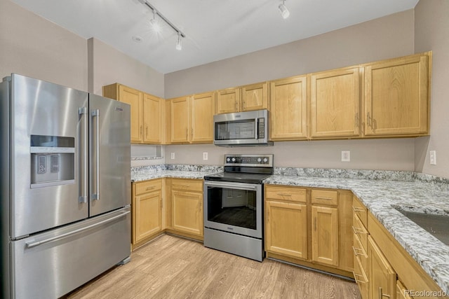 12711 Colorado Blvd Unit 714G, Thornton, CO 80241 - kitchen with stainless steel appliances, light brown cabinetry, rail lighting, and light wood-style flooring