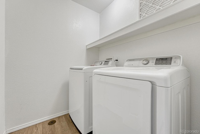 12711 Colorado Blvd Unit 714G, Thornton, CO 80241 - laundry room featuring washing machine and dryer, wood finished floors, and baseboards