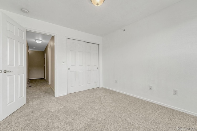 12711 Colorado Blvd Unit 714G, Thornton, CO 80241 - unfurnished bedroom featuring light colored carpet, baseboards, and a closet