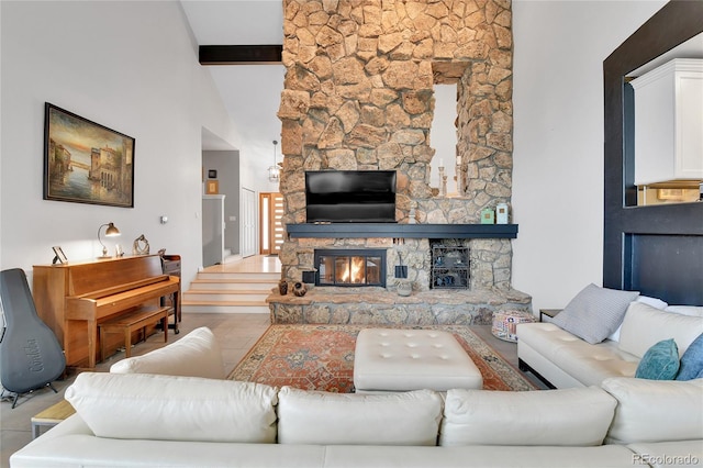 living area with a stone fireplace, tile patterned floors, a high ceiling, and beamed ceiling