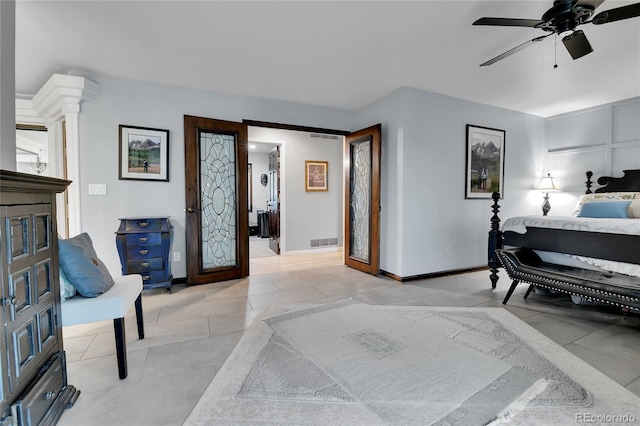 bedroom with visible vents, a ceiling fan, baseboards, and light tile patterned flooring