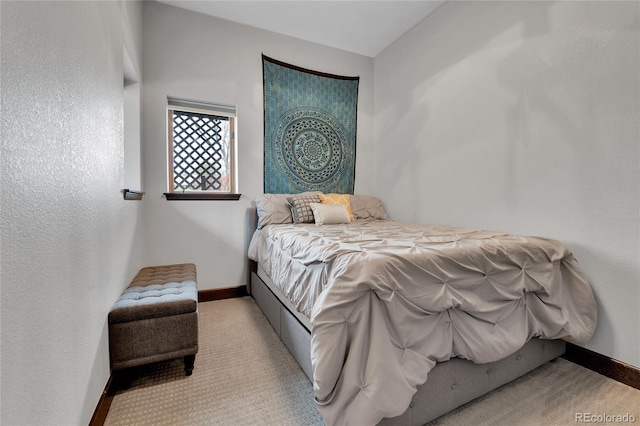 bedroom featuring baseboards and carpet