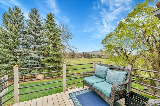 deck featuring a yard and a mountain view