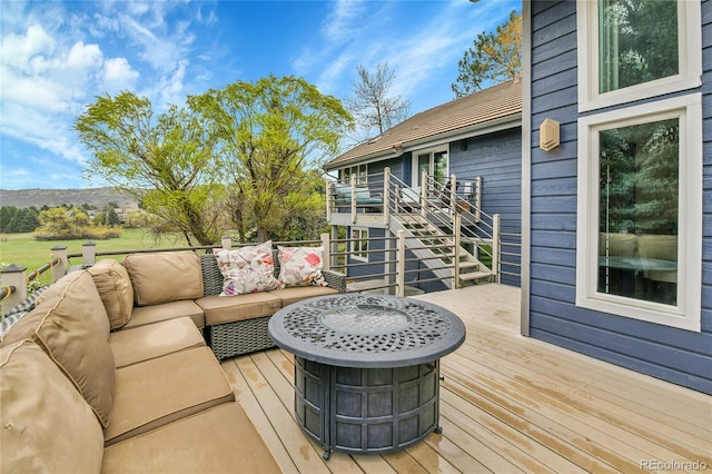 wooden deck featuring an outdoor living space and stairs