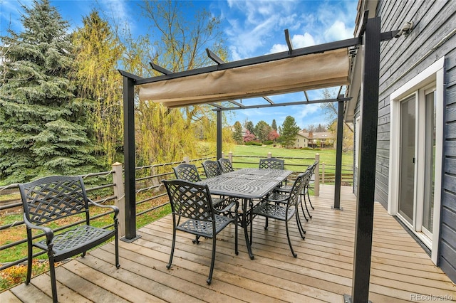 wooden deck with outdoor dining area and a yard