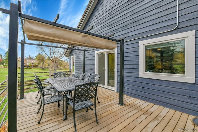 wooden terrace with outdoor dining space
