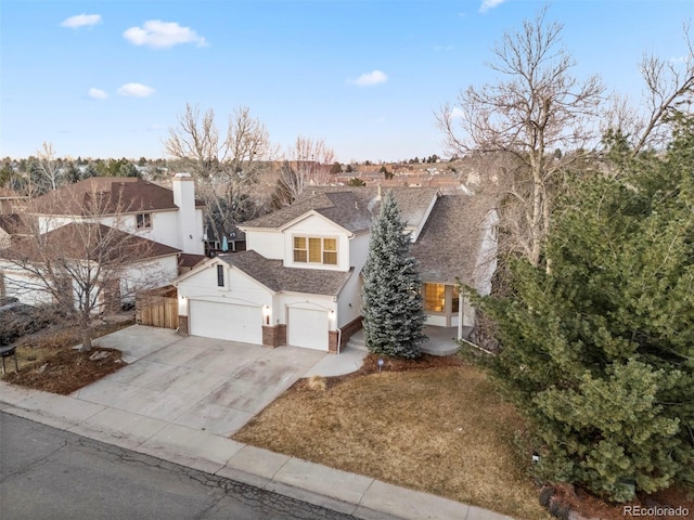 view of front of home with a garage, driveway, a shingled roof, and brick siding