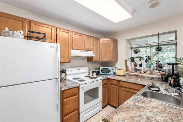 4636 S Dillon Ct Unit B, Aurora, CO 80015 - kitchen with white appliances, under cabinet range hood, a sink, light tile patterned floors, and light countertops