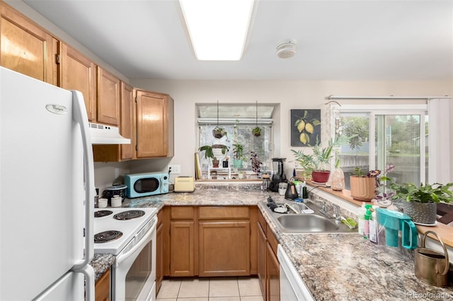 4636 S Dillon Ct Unit B, Aurora, CO 80015 - kitchen with white appliances, under cabinet range hood, a sink, light countertops, and light tile patterned floors