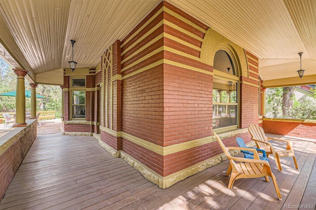 wooden terrace featuring covered porch