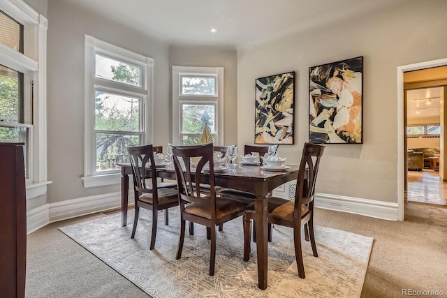 carpeted dining space featuring baseboards and recessed lighting