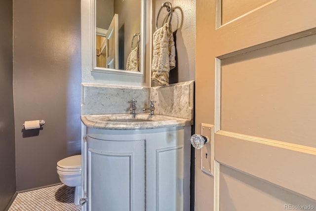 bathroom with vanity, toilet, and tile patterned floors