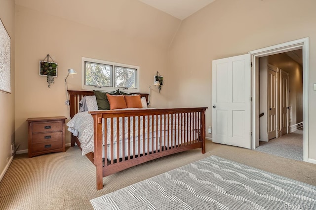 bedroom with carpet floors, vaulted ceiling, and baseboards