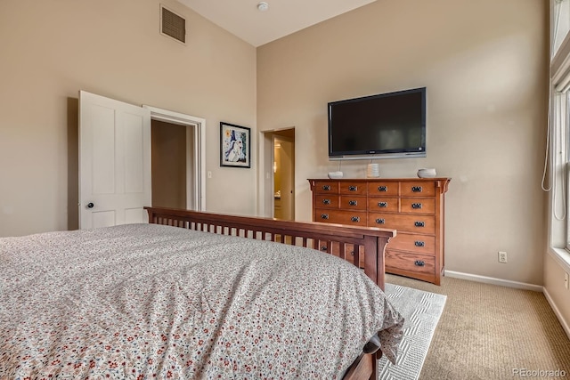 bedroom featuring carpet floors, baseboards, and a towering ceiling