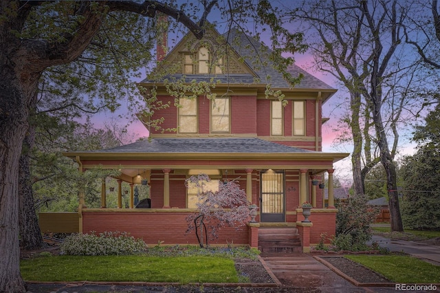 view of front of home featuring a porch and roof with shingles