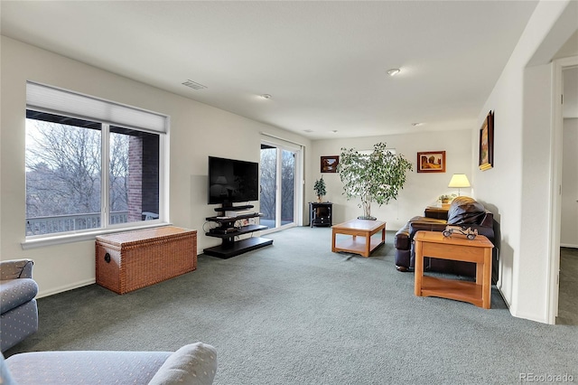 living room with carpet and visible vents