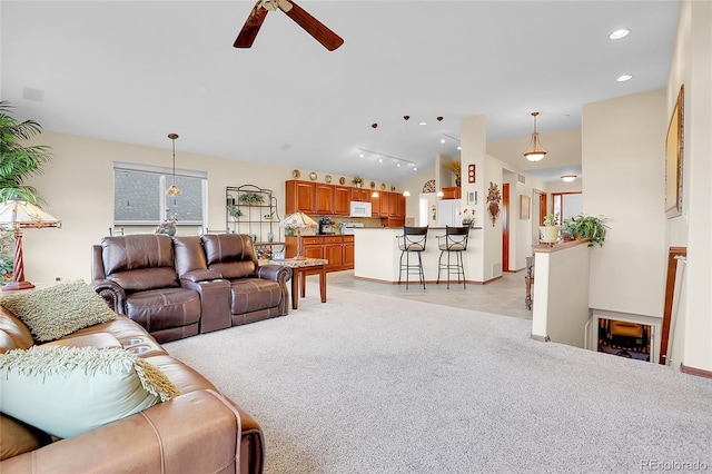 living area with recessed lighting, rail lighting, light carpet, vaulted ceiling, and ceiling fan