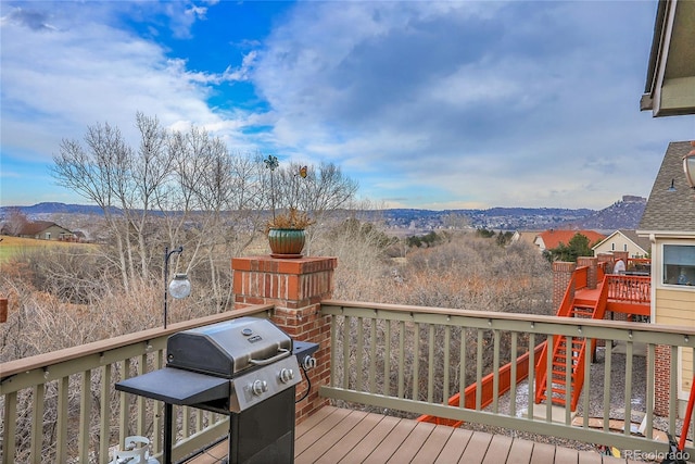 wooden terrace featuring grilling area and a mountain view