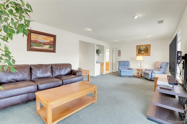 carpeted living area featuring visible vents