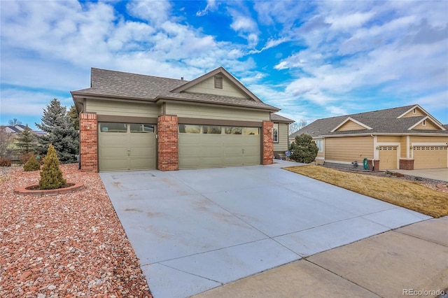 view of front of property featuring a shingled roof, brick siding, driveway, and an attached garage