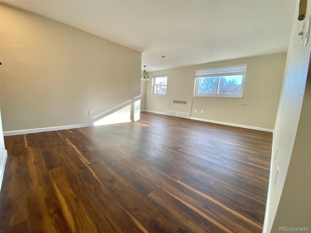 1243 Gaylord St Unit 302, Denver, CO 80206 - spare room with a chandelier, dark wood finished floors, and radiator