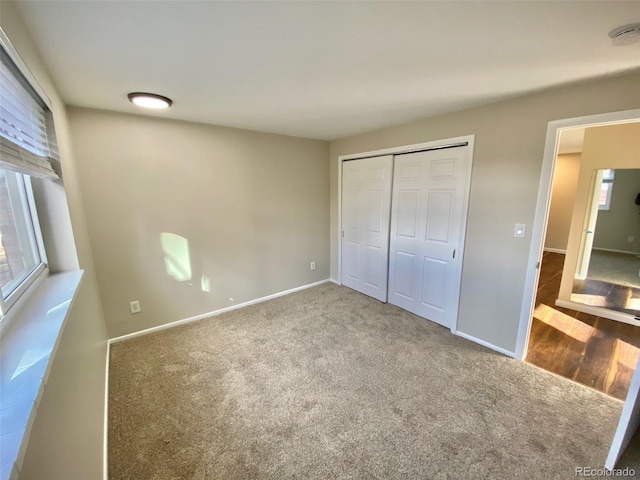 1243 Gaylord St Unit 302, Denver, CO 80206 - unfurnished bedroom with carpet floors, a closet, and multiple windows