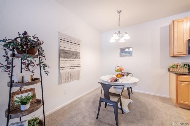 dining space with baseboards, a chandelier, and light colored carpet