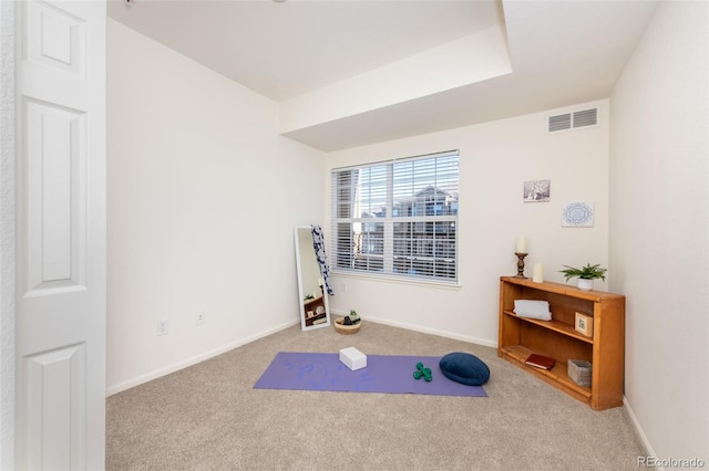 workout area with baseboards, visible vents, and carpet flooring