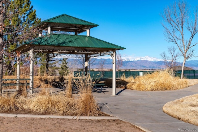 surrounding community with a mountain view and a gazebo