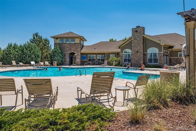 community pool featuring a patio area