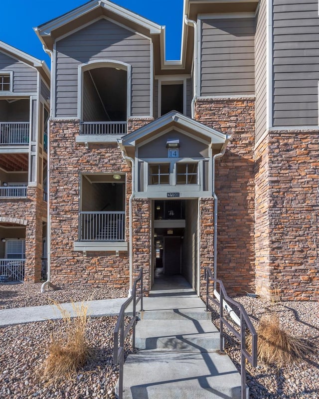 entrance to property featuring stone siding