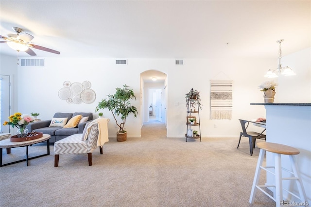 3100 Blue Sky Cir Unit 205, Erie, CO 80516 - living area featuring arched walkways, ceiling fan, light colored carpet, and baseboards