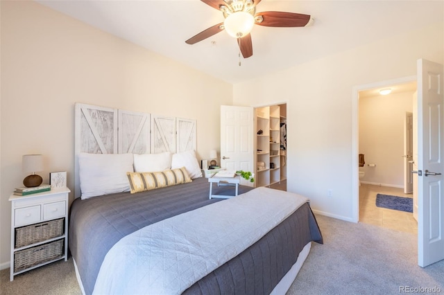 3100 Blue Sky Cir Unit 205, Erie, CO 80516 - carpeted bedroom with a walk in closet, ensuite bath, baseboards, and a ceiling fan