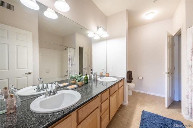 3100 Blue Sky Cir Unit 205, Erie, CO 80516 - full bathroom featuring toilet, tile patterned flooring, double vanity, baseboards, and curtained shower
