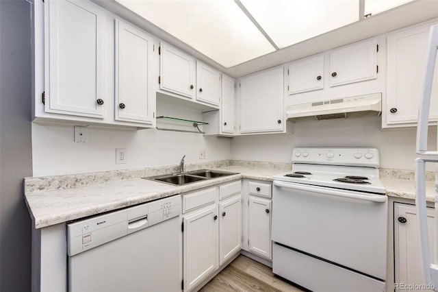 kitchen with white cabinets, white appliances, light hardwood / wood-style floors, and sink