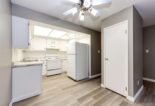 kitchen featuring white appliances, a textured ceiling, sink, white cabinets, and ceiling fan