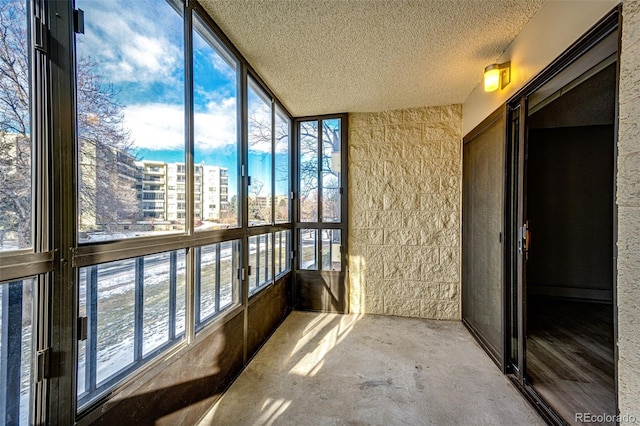 unfurnished sunroom featuring lofted ceiling