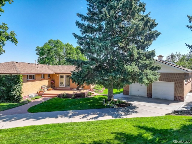 view of front of property with a garage and a front yard