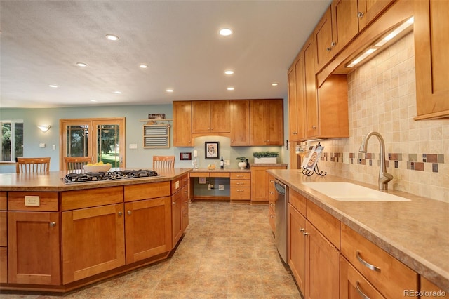 kitchen featuring appliances with stainless steel finishes, sink, and decorative backsplash