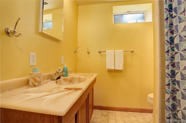 bathroom with vanity, walk in shower, and toilet