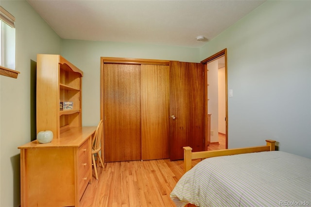 bedroom featuring light hardwood / wood-style flooring and a closet