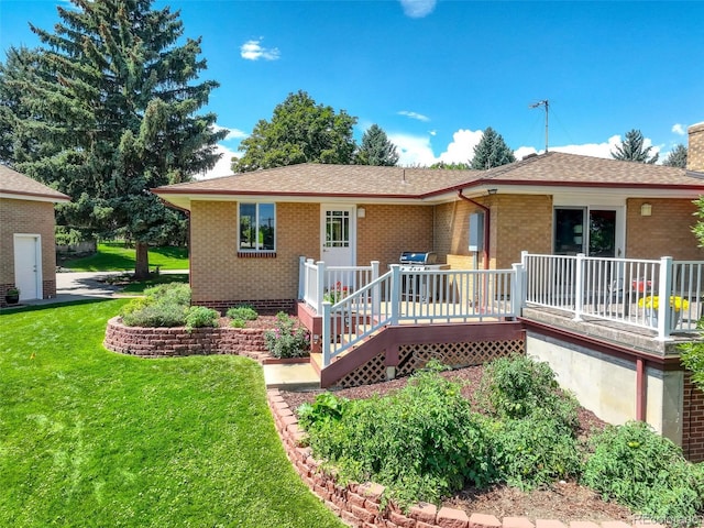 back of house with a yard and a deck