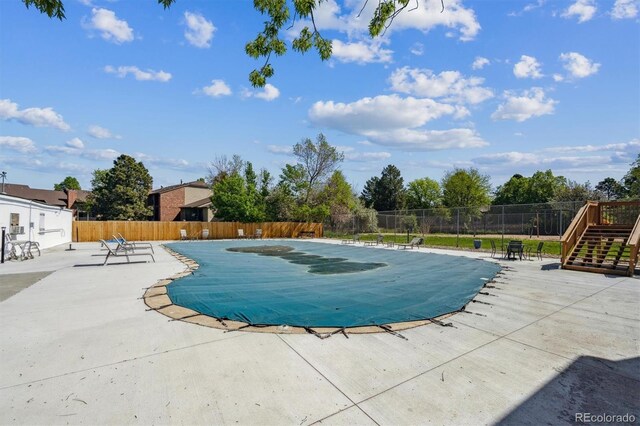 community pool featuring a patio area and fence